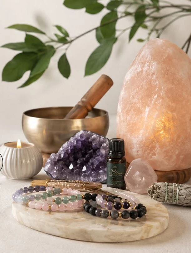 Bliss collection featuring crystal bracelets, amethyst, a singing bowl, candle and Himalayan salt lamp